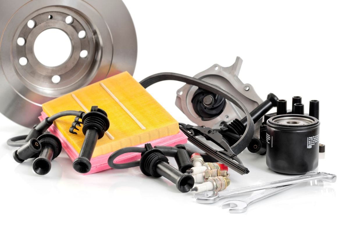 An assortment of automotive parts, including brake pads, brake discs, and additional car components. 